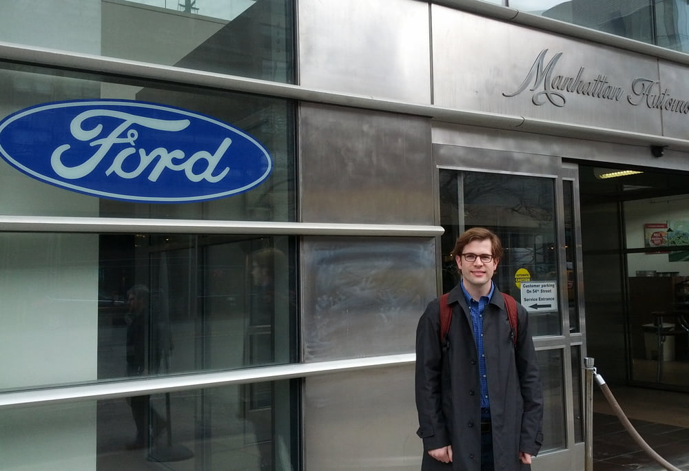 Chris standing outside the Ford of Manhattan dealership