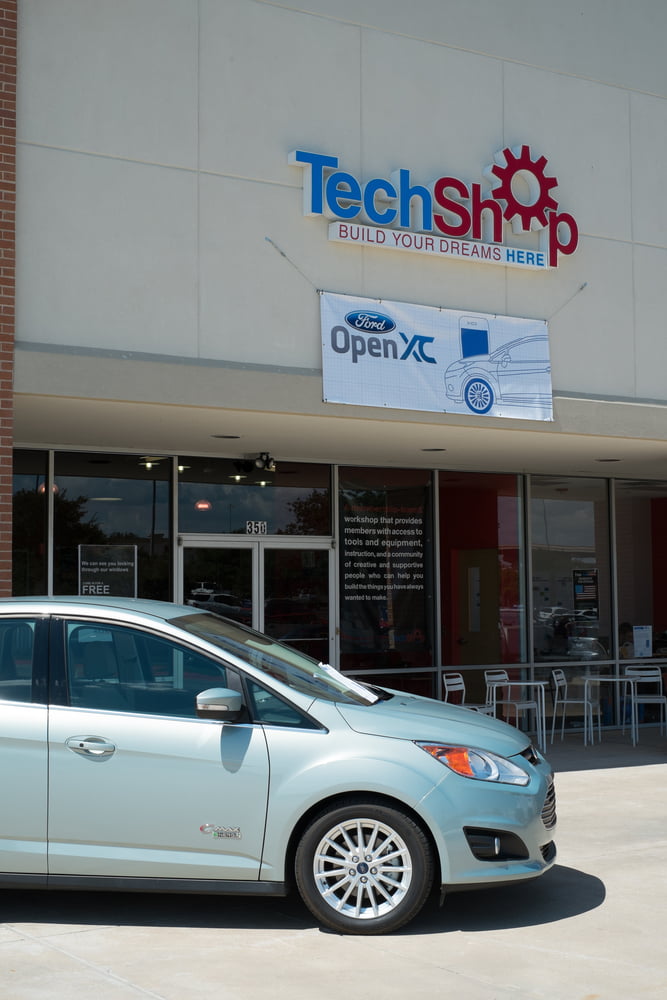 Exterior of TechShop in Round Rock with OpenXC banner and Ford C-Max car